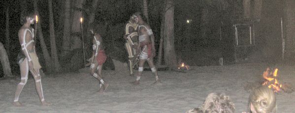 Ritual dances in sand pit around fire